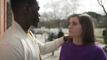 Interracial couple together. African man caressing girlfriend