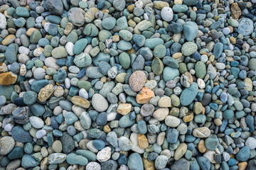 Multi-colored pebbles on the beach on the Black Sea. Pebble background. Coast. Pebble texture