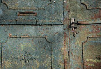 textured surface of a metal rusty door, yellow blue and rusty color, old painting of a vintage forged entrance gate, beautiful rust on metal, door handle, geometric shapes