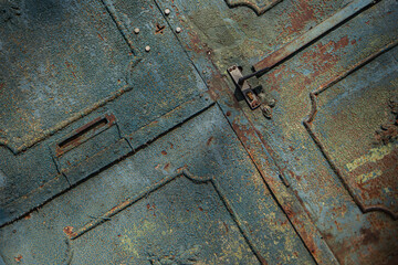 textured surface of a metal rusty door, yellow blue and rusty color, old painting of a vintage forged entrance gate, beautiful rust on metal, door handle, geometric shapes