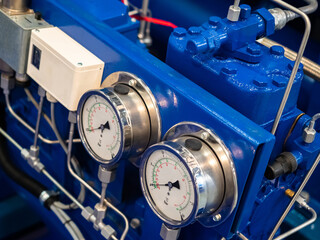 A fragment of the equipment of a food production plant. Blue compressor with measuring instruments....