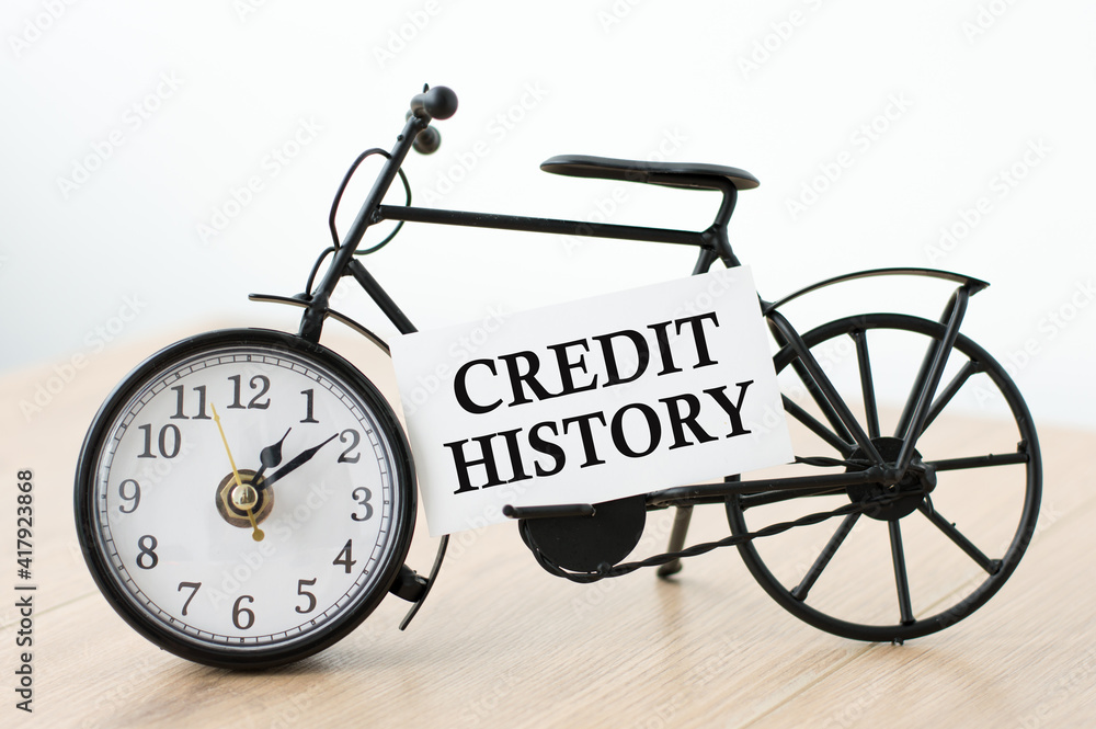Poster clock and card with text credit history on isolated light table