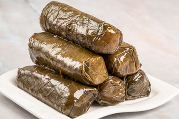 stuffed grape leaves with olive oil on plate on the table