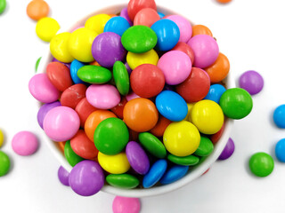 Bright multi colour chocolate gemes on white background