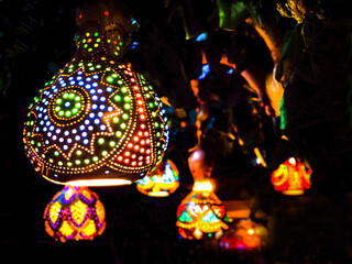 Oriental lanterns glow with multicolored lights in the dark