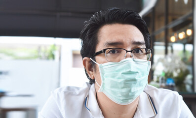 Fototapeta na wymiar Asian men wearing mask for protect air pollution, and coronavirus concept