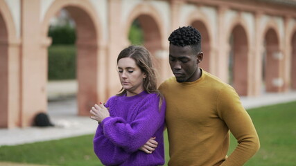 Fototapeta premium Male friend consoling depressed young woman. interracial couple partnership