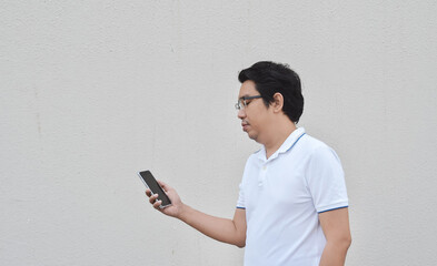 Asian man using smartphone,  isolated on gray background - 417925085