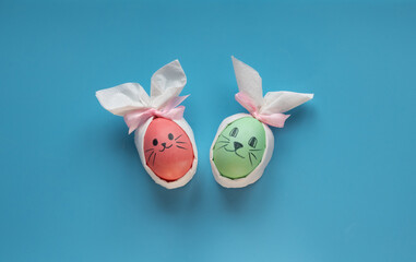 Eggs with smiling eyes and green medical or hygienic mask on wood background, Preparing for protection children from Covid 19 or Corona virus pestilence on Easter day concept