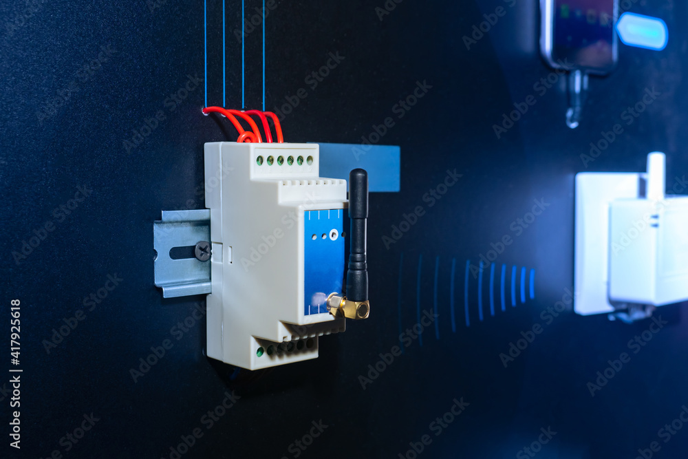 Poster radio relay unit is fixed to a din rail on a dark wall. wireless power supply control unit. device f