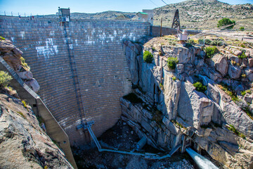Alcova, Wyoming - 6/27/2018: Pathfinder dam, with water exiting the power house, constructed in...