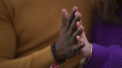 Two people joining hands together, diversity concept. interracial couple close-up hand