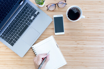 Overhead View Of Businessman Working At Computer In Office.