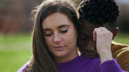 Loving interracial couple together outside, care and affection