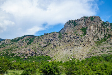 Overview of tall mountains & massive fallen multi-ton boulders in Valley of Ghosts, near Alushta, Crimea