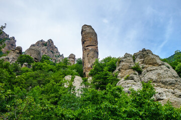 One of stone erosion pillars, remains of prehistoric rock, standing among mountains & forest. Shot in Valley of Ghosts, near Alushta, Crimea