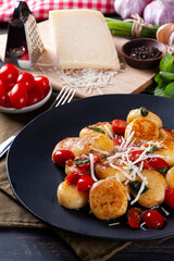 Artisan gnocchi stuffed with cheese, with cherry tomatoes, garlic, olive oil and basil