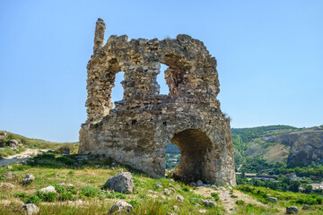 Fototapeta na wymiar Remains of medieval tower with gates, part of fortress Kalamita, Crimea. It was founded by Byzantines in VI. In XV it was captured by Turks. Now it's quiet tourist place nearby Inkerman Cave Monastery