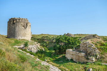 Fototapeta na wymiar Tower and walls of medieval fortress Kalamita, Inkerman, Crimea. It was founded by Byzantines on top of rock with cave church that later became Inkerman Monastery of St Clement (still exist)