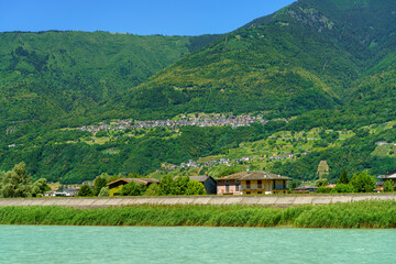 Fototapeta premium The Adda river along the Sentiero della Valtellina at summer