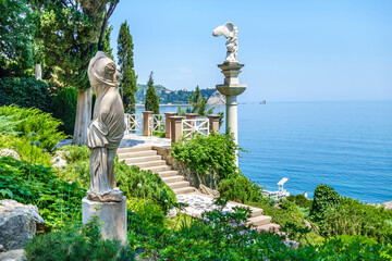 Ancient statues of Greek goddesses in garden nearby sea. Shot in park Paradise (or Aivazovsky) in Partenit on coastline of Black Sea, Crimea - obrazy, fototapety, plakaty