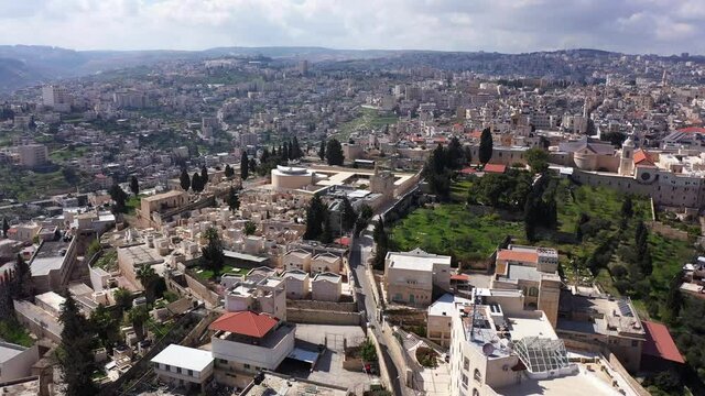 Arial view over Church of the Nativity And City Square Of Bethlehem
, Morning shot from Bethlehem, the town where Jesus was born. Place of The Church of the Nativity
