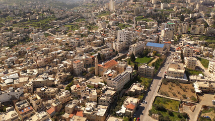 Obraz premium Aerial view over Bethlehem City, Palestinian Authority Drone view over buildings and fields in the morning, March 2021 