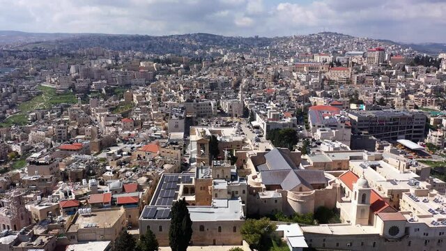 Aerial view over Church of the Nativity And City Square Of Bethlehem
, Morning shot from Bethlehem, the town where Jesus was born. Place of The Church of the Nativity
