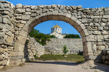 Fototapeta na wymiar Golden dome of Vladimir's Cathedral as it looks through the street arch in antique city Chersonesus, Sevastopol, Crimea