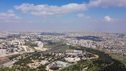 Obraz premium Jerusalem City wide aerial Flight view Drone high altitude view of Jerusalem,clouds and Blue skies March 2021 Israel 