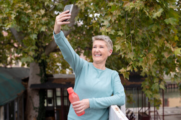 Mature woman taking a selfie during jogging