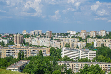Fototapeta na wymiar Panorama of a residential quarter of post-Soviet city. It's possible to see many classic types of buildings traditional for Eastern Europe and former USSR countries in 2nd half of XX century.