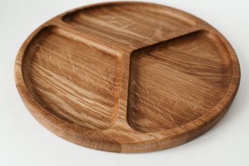 Compartmental dish on a white background. Dishes made of natural materials. Wooden bowl.