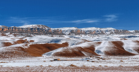 the Bermamyt plateau. Rocky ridge of the Greater Caucasus. Sandy-rocky rocks. Snow on the sand....