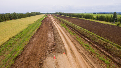 Drone view of the new road. Aerial photography construction of a new highway. Construction stage. Road pavement layers. The composition of the road during its construction
