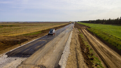 Drone view of the new road. Aerial photography construction of a new highway. Construction stage. Road pavement layers. The composition of the road during its construction