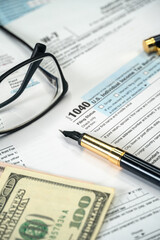 Filling US tax form 1040. Tax time for USA business income return tax and irs. Vertical photo