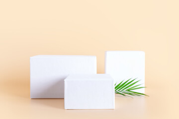 White empty podium stands on neutral beige background.