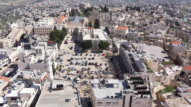 Aerial view over Church of the Nativity And City Square Of Bethlehem
, Morning shot from Bethlehem, the town where Jesus was born. Place of The Church of the Nativity
