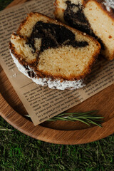 Cut sweet roll on baking paper. Strudel sprinkled with powdered sugar. Piece of sweet pastry.