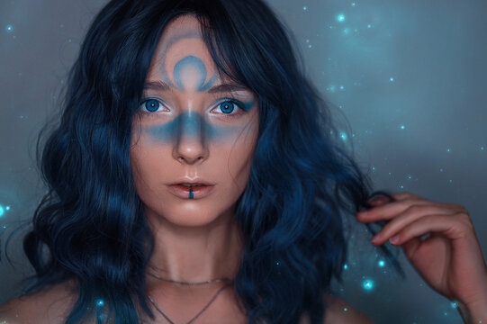 Beauty portrait of a European girl in a magical style. Blue hair, creative makeup