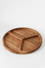 Compartmental dish on a white background. Dishes made of natural materials. Wooden bowl.