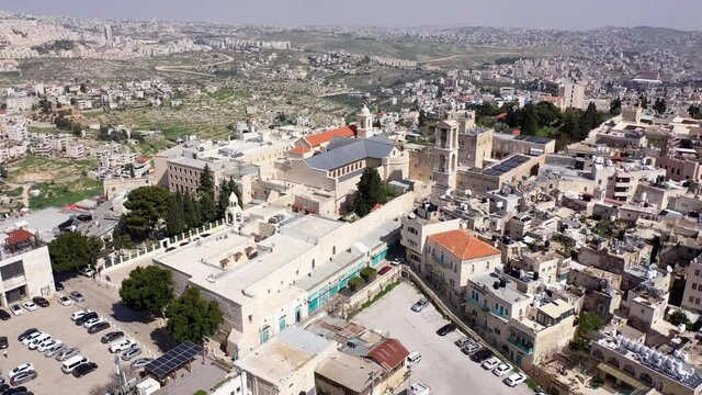 Aerial view over Church of the Nativity And City Square Of Bethlehem
, Morning shot from Bethlehem, the town where Jesus was born. Place of The Church of the Nativity
