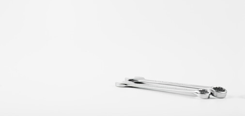 Wrench on a white background. Combined open-end wrench for taps. Plumbing tool.