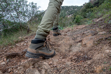 close up of hiking shoe in rocky trail