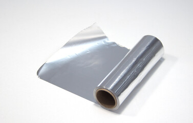 A roll of aluminum foil on a white background. Foil for the hairdresser