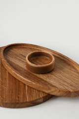 A stack of wooden plates on a white background. Three round ash wood pieces.