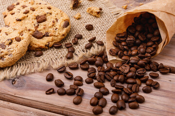 Cookies and coffee beans on wooden surface