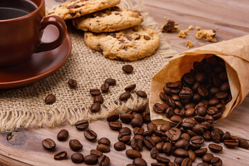 Cup of coffee with biscuits and coffee beans
