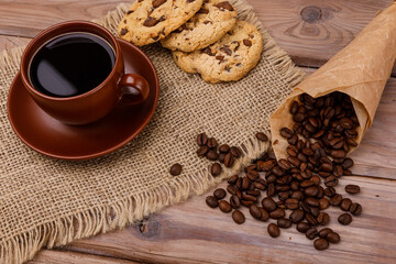 Cup of coffee with biscuits and coffee beans